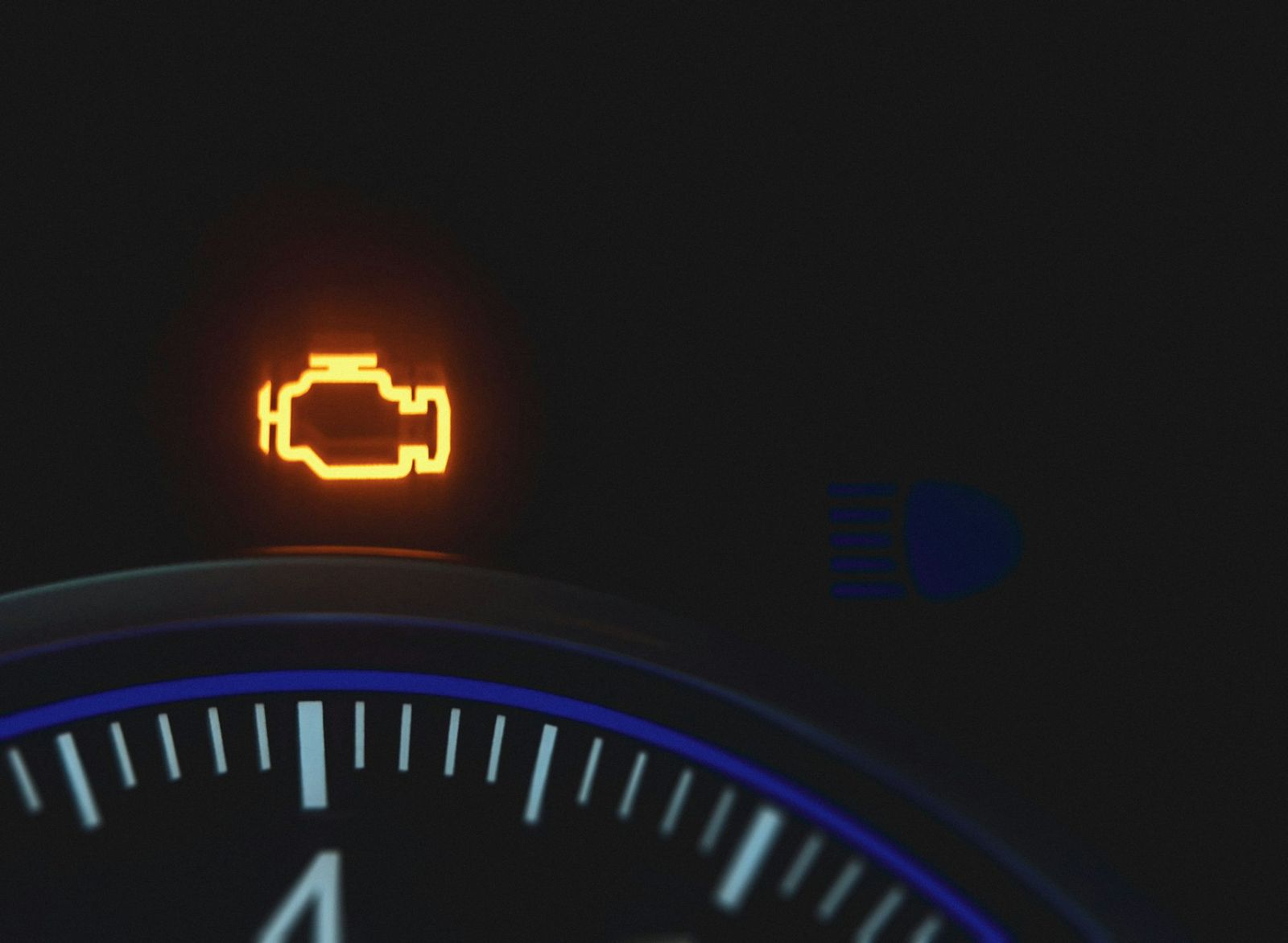 Check engine warning light on a car dashboard
