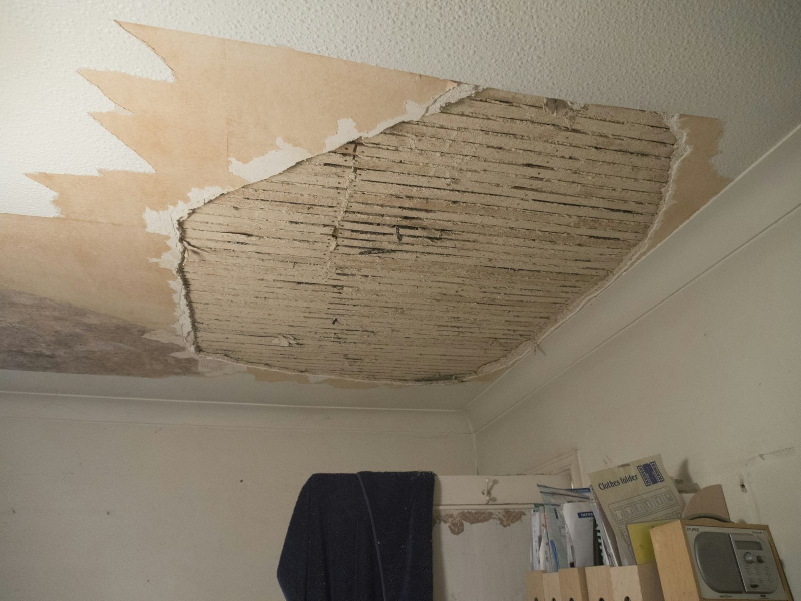 Ceiling torn open by water damage